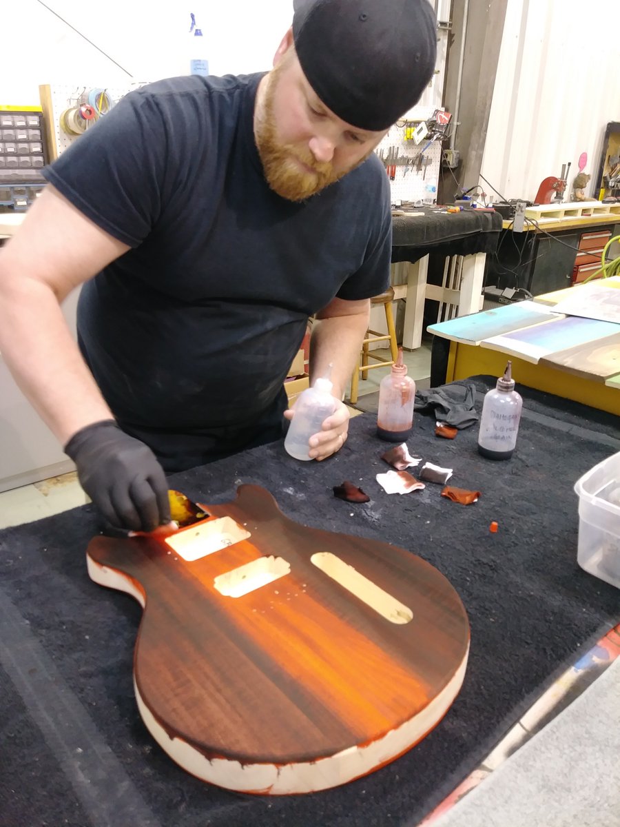 GuitarBuild01's tweet photo. As James continued staining the body of his guitar, it took on a deep red orange color. Assembly is next. #guitar #Nashville #thingstodo https://t.co/wkJnn4myL3