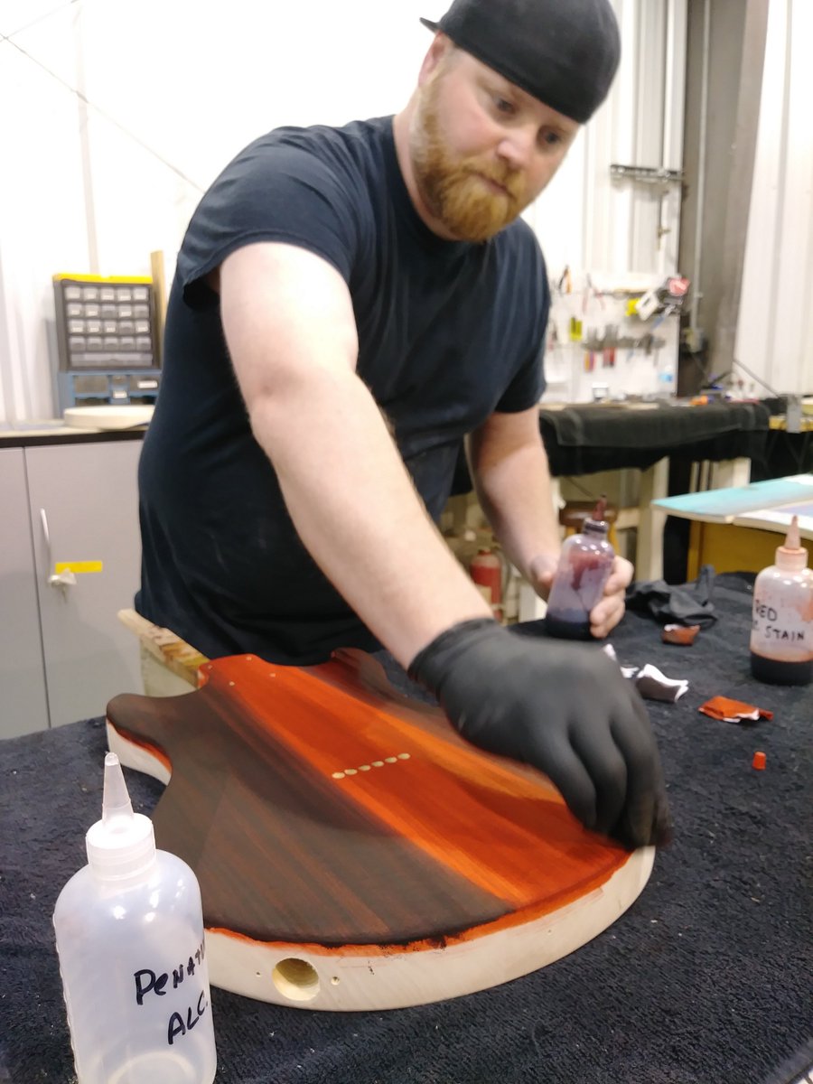 GuitarBuild01's tweet photo. As James continued staining the body of his guitar, it took on a deep red orange color. Assembly is next. #guitar #Nashville #thingstodo https://t.co/wkJnn4myL3