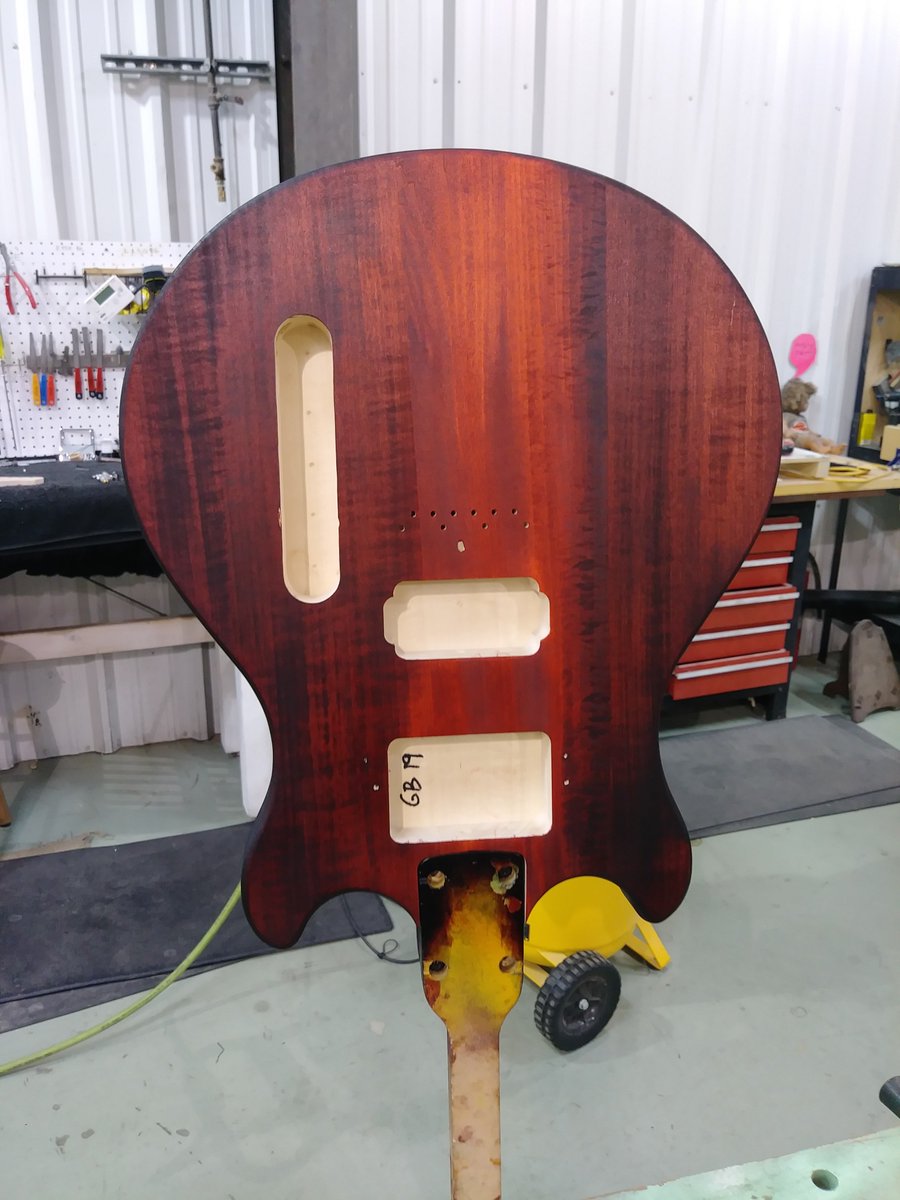 GuitarBuild01's tweet photo. As James continued staining the body of his guitar, it took on a deep red orange color. Assembly is next. #guitar #Nashville #thingstodo https://t.co/wkJnn4myL3
