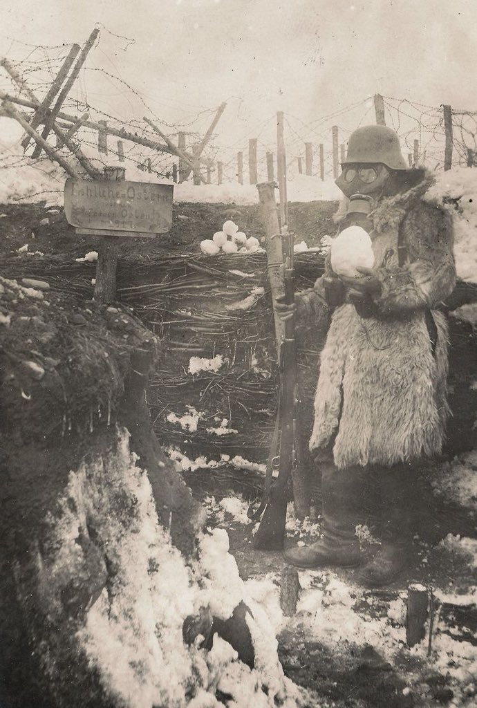 German soldier sporting a goat or sheep skin coat on the the western front, 1917. Notice the pile of snowballs behind him. #ww1