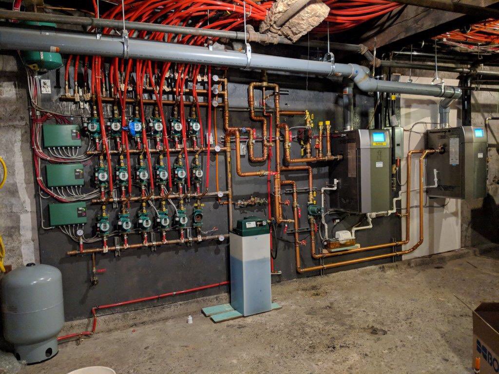 upgrade to the LX400 boiler on the left which turned out to be undersized for the building load.The old 1000 MBH steam boiler was damaged by the 2013 flood in Calgary. Initially only the left hand boiler was installed and <a href="/wefixheating/">General Plumbing and Heating</a> installed the second LX400 boiler. Great job