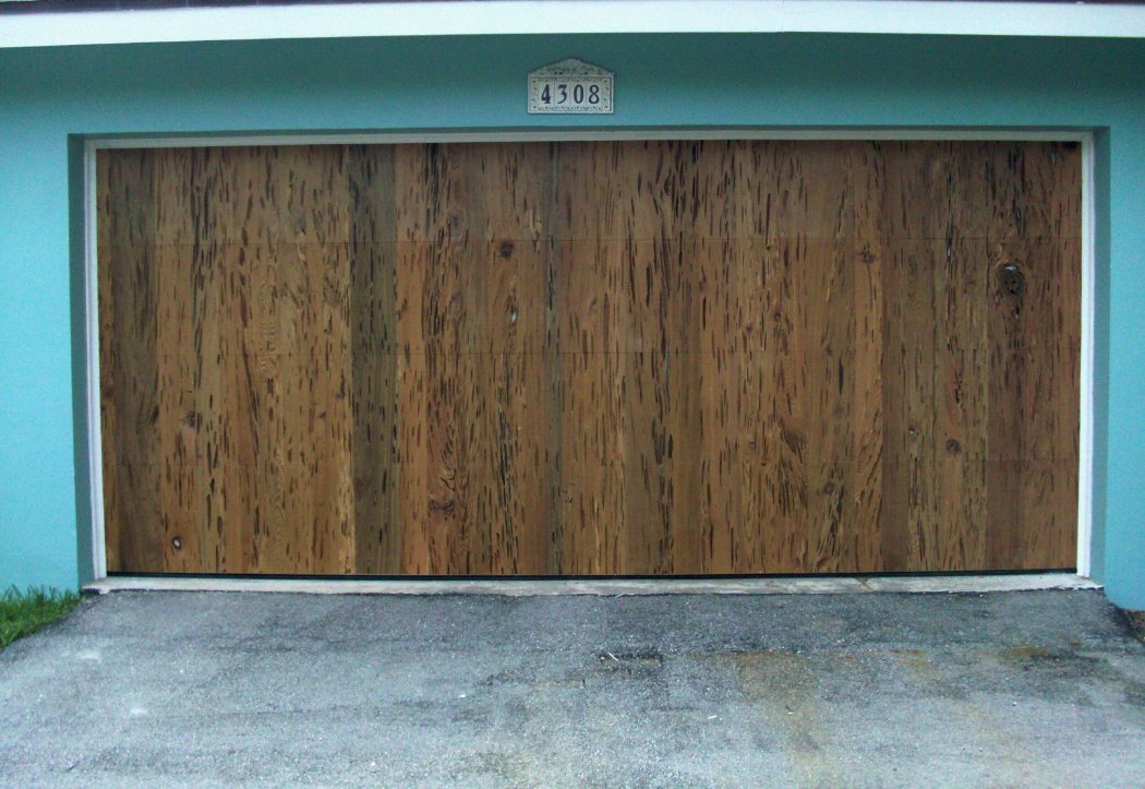 A pecky cypress garage door creates a unique home appearance |@FloridaCypress bit.ly/2KzLI4N