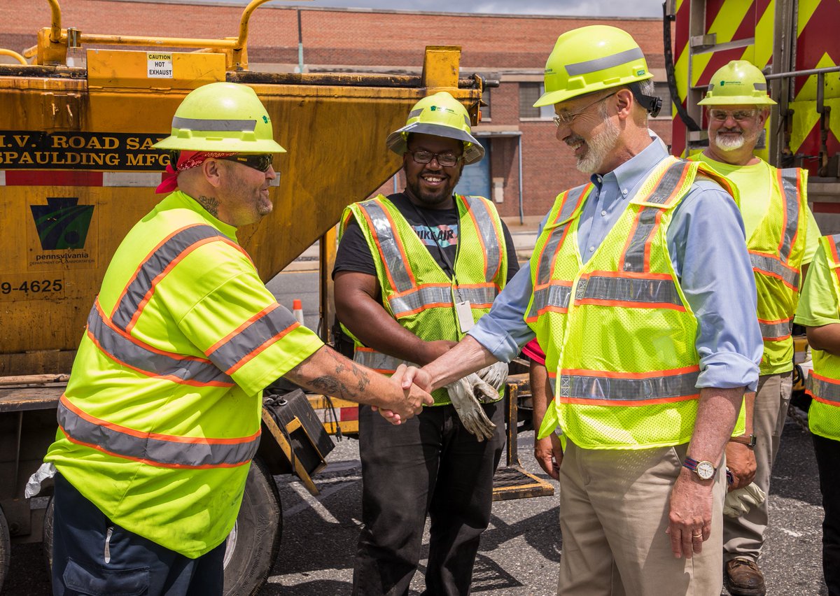 Image of Governor Tom Wolf shaking hands with PennDOT workers.