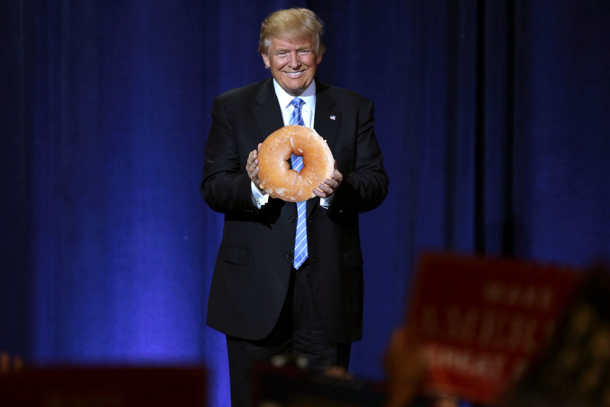 TrumpolicyGame's tweet photo. Some may say large donut. Others may say small hands. Either way we're hyped it's #NationalDonutDay.  #NationalDoughnutDay #FridayFeeling https://t.co/fs4NvOkqlP