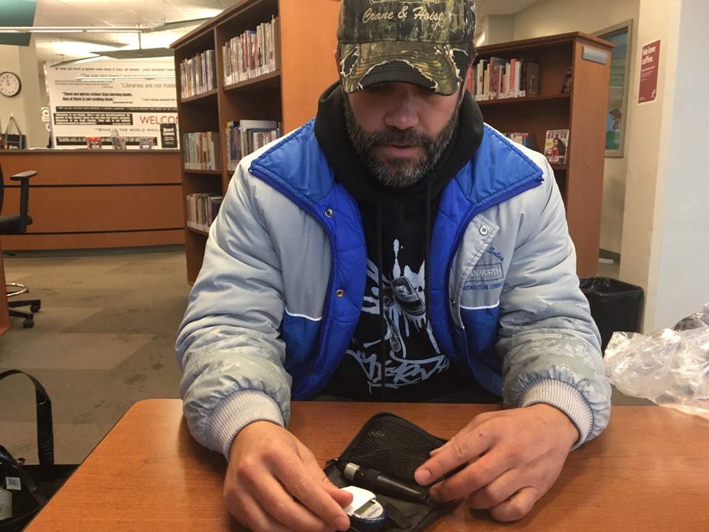 AliceKuipers's tweet photo. Safe and dry. #saskatoonpubliclibrary gives us shelter from the rain as @BamfordSask checks his blood sugar levels #SanctumSurvivorYXE (and there are books, too ;-) https://t.co/18BKl3aph0