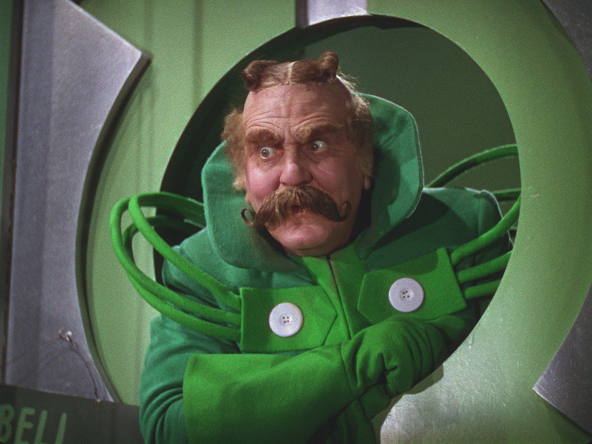 In The Wizard of Oz (1939), Frank Morgan portrays 5 characters including  The Gatekeeper, The Coachman, The Guard and The Wizard. He is literally  gate keeping himself and is so touched by