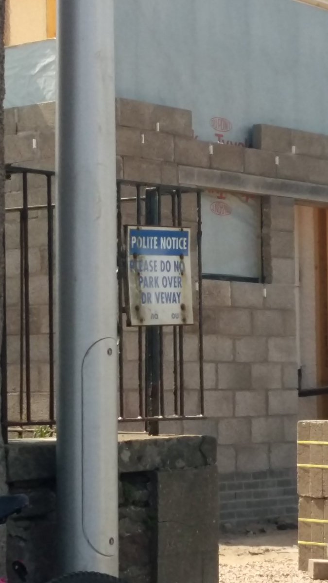 A polite notice sign which reads 'Please do not park over driveway' where the letter I has fallen off from driveway to look like Dr Veway.