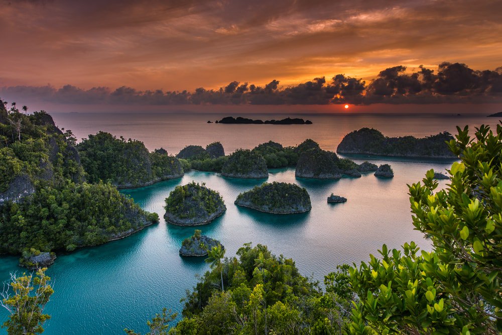 Sunsets are among the best sights in this archipelago in Papua, Indonesia. The pristine nature, tall rock formations, lush jungles, clear ocean, even the fresh breeze and seawater scent, all conspires to intensify this precious event of the day.