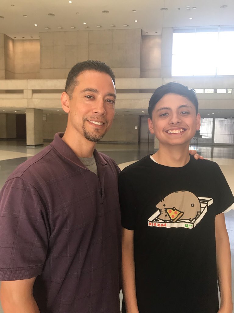 My youngest and I waiting in line to see my middle son graduate.  #oneprouddad