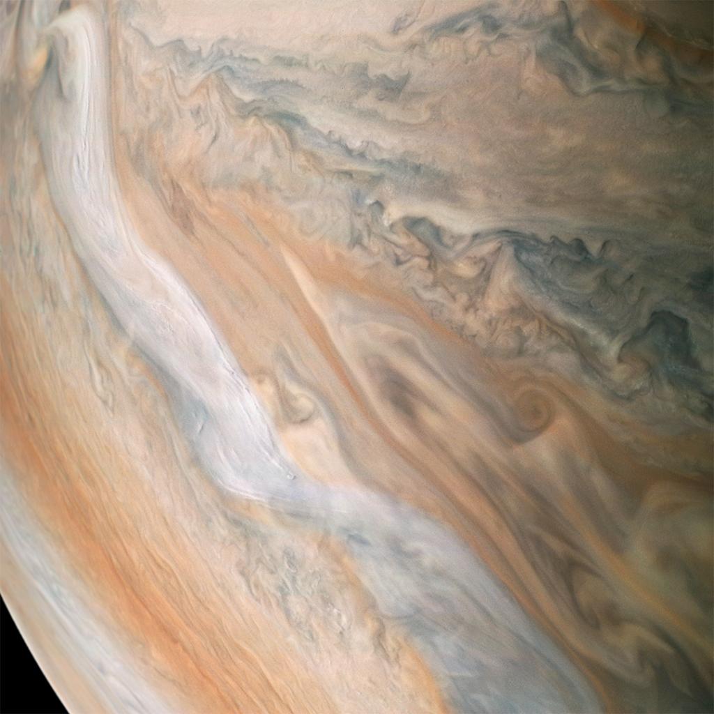 NASA's tweet photo. A jet stream is seen speeding through Jupiter’s atmosphere in this new view from @NASAJuno. The jet stream, visible in white from top left to bottom right, was captured along the dynamic northern temperate belts of the gas giant planet. Look closer: https://t.co/qQwPiNgXCp https://t.co/vZ0DsvEhvO