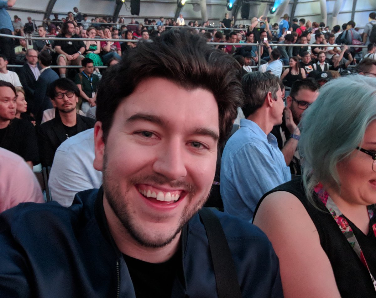 JakeBaldino's tweet photo. When you take a dumb solo portrait mode selfie at the E3 Sony press conference and you don't realize until days later KOJIMA WAS THERE THE WHOLE TIME. FUCK! https://t.co/bAHxDGNwLc