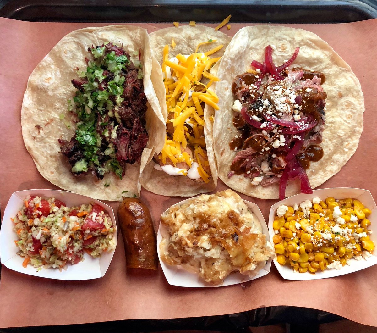 Having a great time serving smoked meat tacos with <a href="/BBQBryan/">BBQ Bryan</a> today. Barbacoa, pulled pork with 4 Horsemen molè, and chicken enchilada sausage with crema and cheddar.