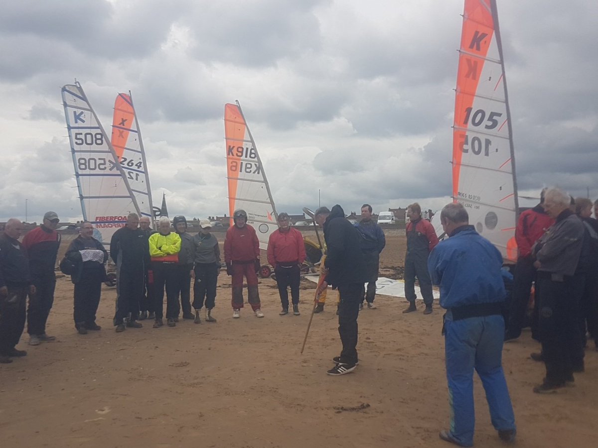 LandsailRedcar's tweet photo. Pilot briefing ahead of the first race. It will be the minis first, followed by the class 5/Standarts, with the class 3s (largest) going off last. Wind is beautiful! #RideTheWind

@RedcarCleveland https://t.co/KXJNywjXjU