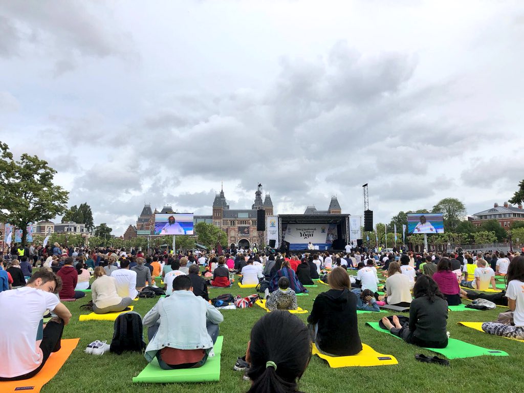 Gurudev's tweet photo. Conducted yoga and meditation in Museumplein, Amsterdam as part of the International Yoga Day celebrations. There is no better way to tackle aggression and depression, the two ills afflicting society, than through yoga. #IDY2018 https://t.co/FihLxTrcNH