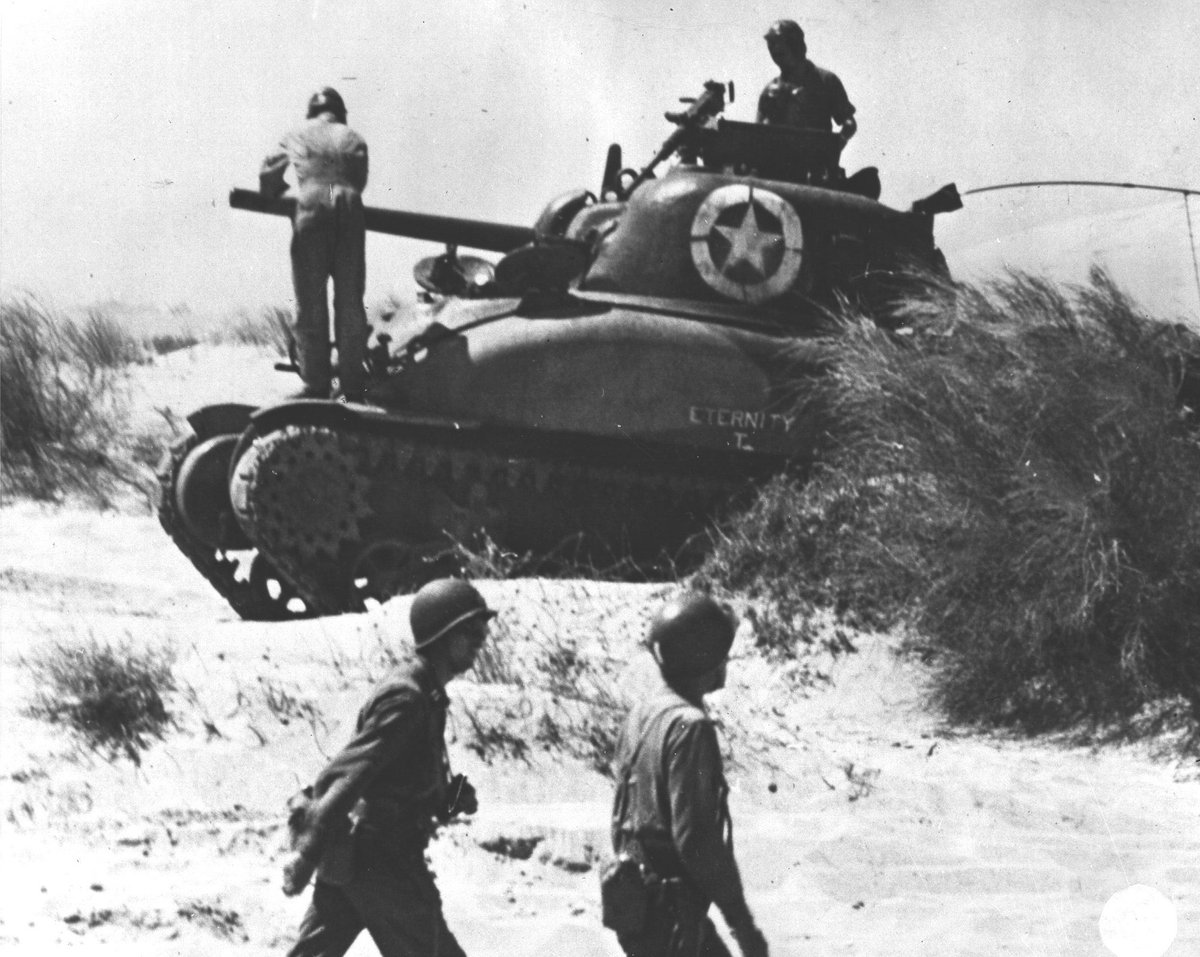 WW2Facts's tweet photo. The crew of M4 Sherman tank 'Eternity' checking the tank after landing at Red Beach 2, #Sicily, on July 10, 1943. 

#History #WWII https://t.co/bySqMMdU5s