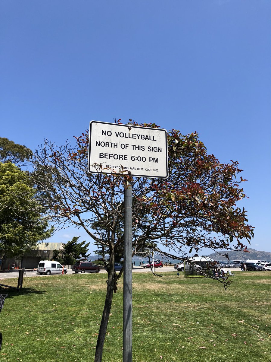 Sign says "no volleyball north of this sign before 6pm"