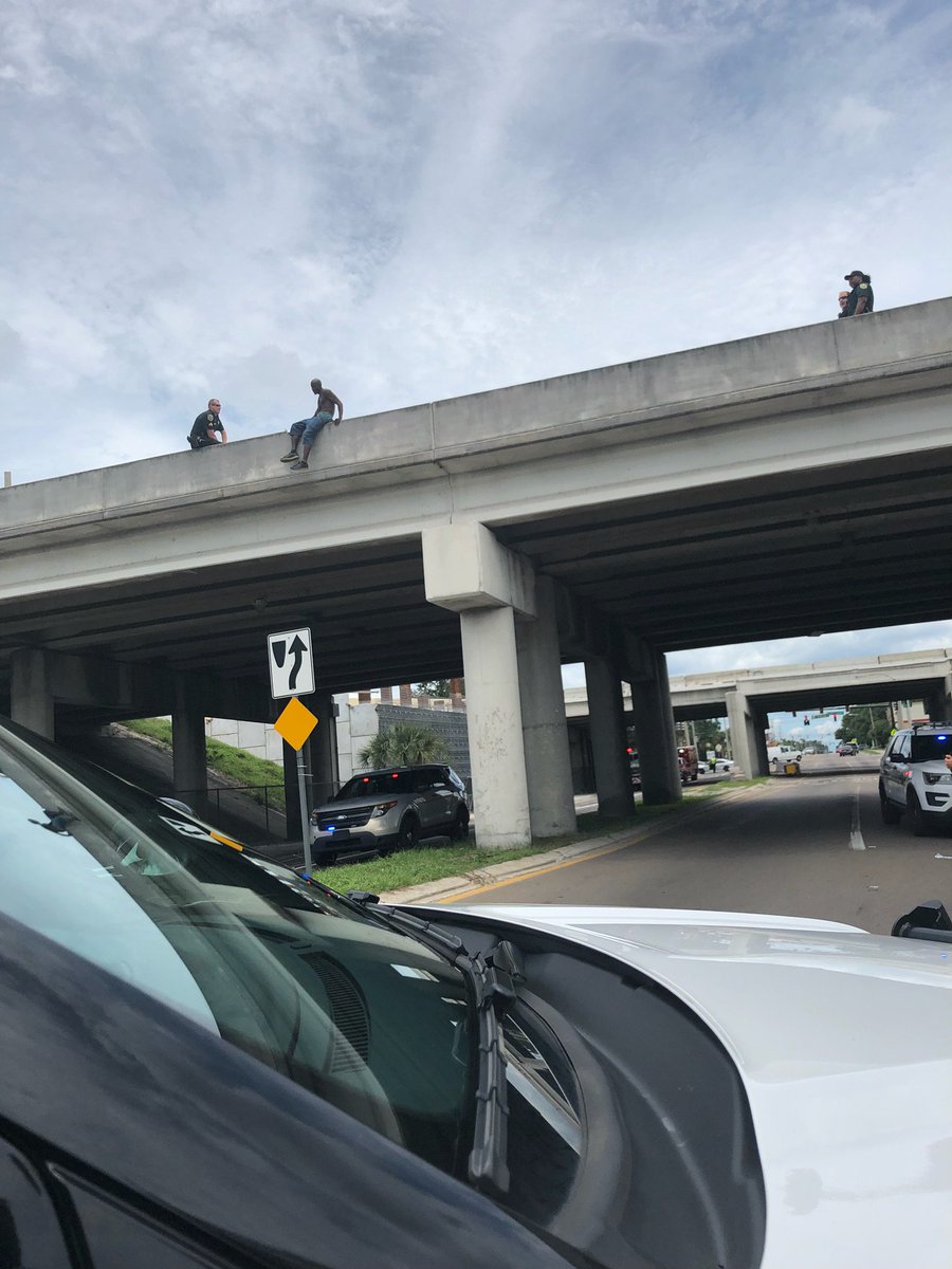 OrangeCoSheriff's tweet photo. OCSO Sgt Jamie Hoffman talking a man off of a ledge on the I-4 overpass above Rio Grande Ave/33rd Street.  The Sgt built a rapport with him and gained his trust to come off of the ledge. The man was taken away for help.  Sgt Hoffman and responding deputies, making a difference. https://t.co/B6vXW2PYQu