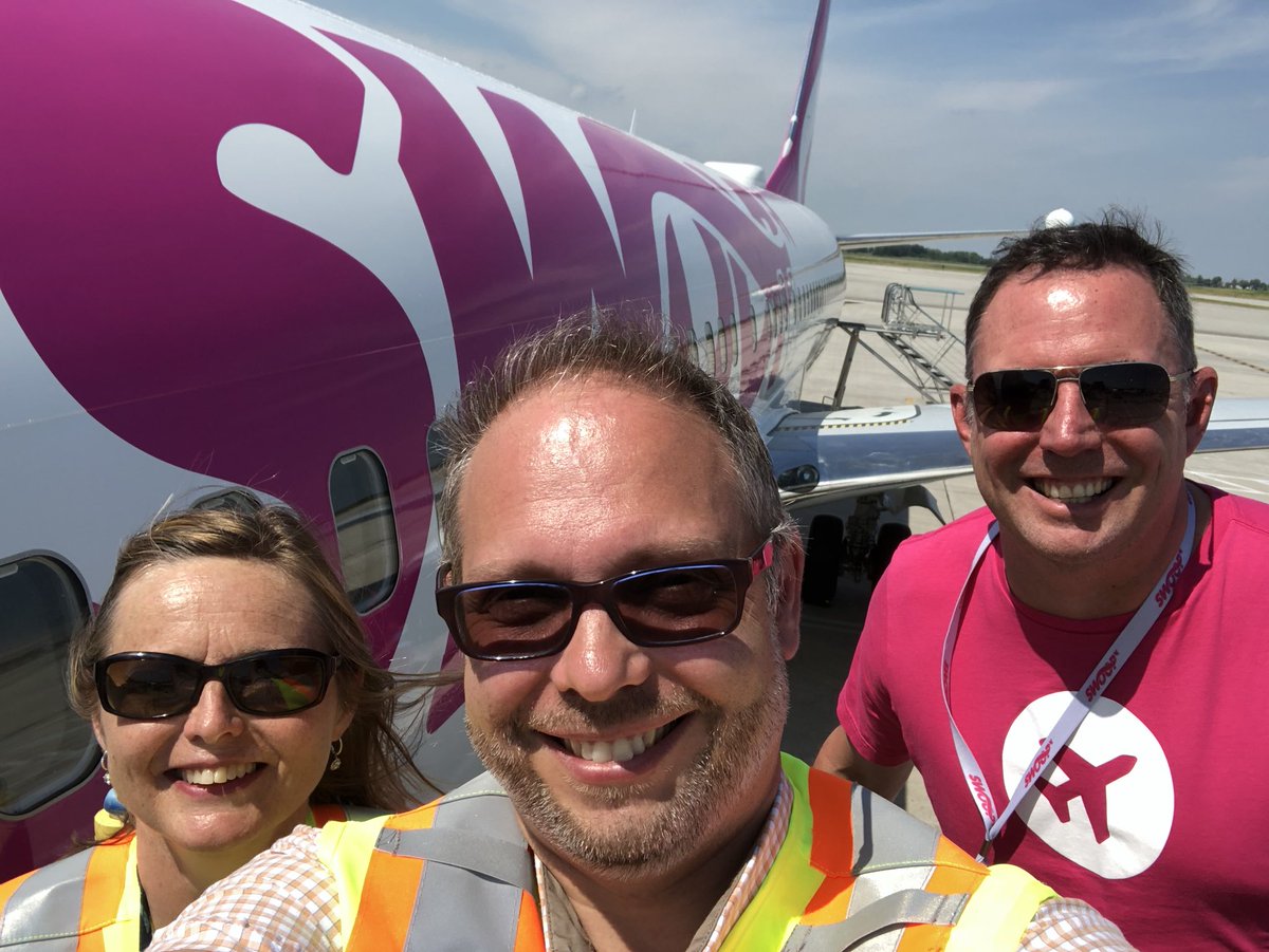 YHMDirOps's tweet photo. Flanked by the 2 CEOs...we welcome @FlySwoop to @flyyhm. And no, my forehead is the same size as it always was #RecedingHair. #Welcome #Hamilton #HamOnt https://t.co/dzOOAepqYU