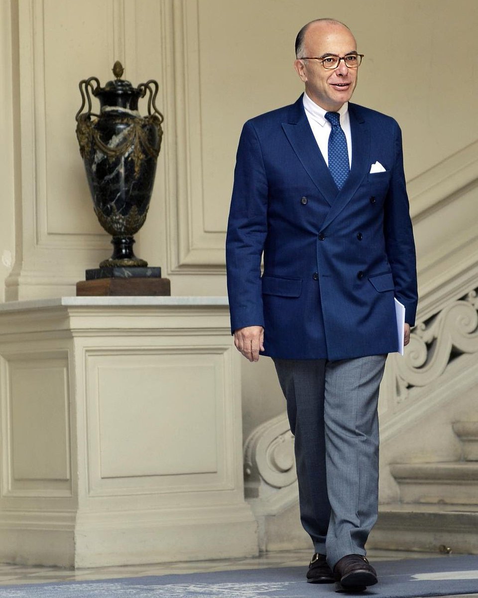 OSCazeneuve's tweet photo. Veste de costume croisée marine ; chemise, pochette et documents importants assortis ; pantalon anthracite ; chaussures à boucle : Bernard Cazeneuve est un peu le Don Draper de la politique. (Paris, le 7 juin 2015.) Photo : @loicvenance AFP https://t.co/ErFDoOKjto