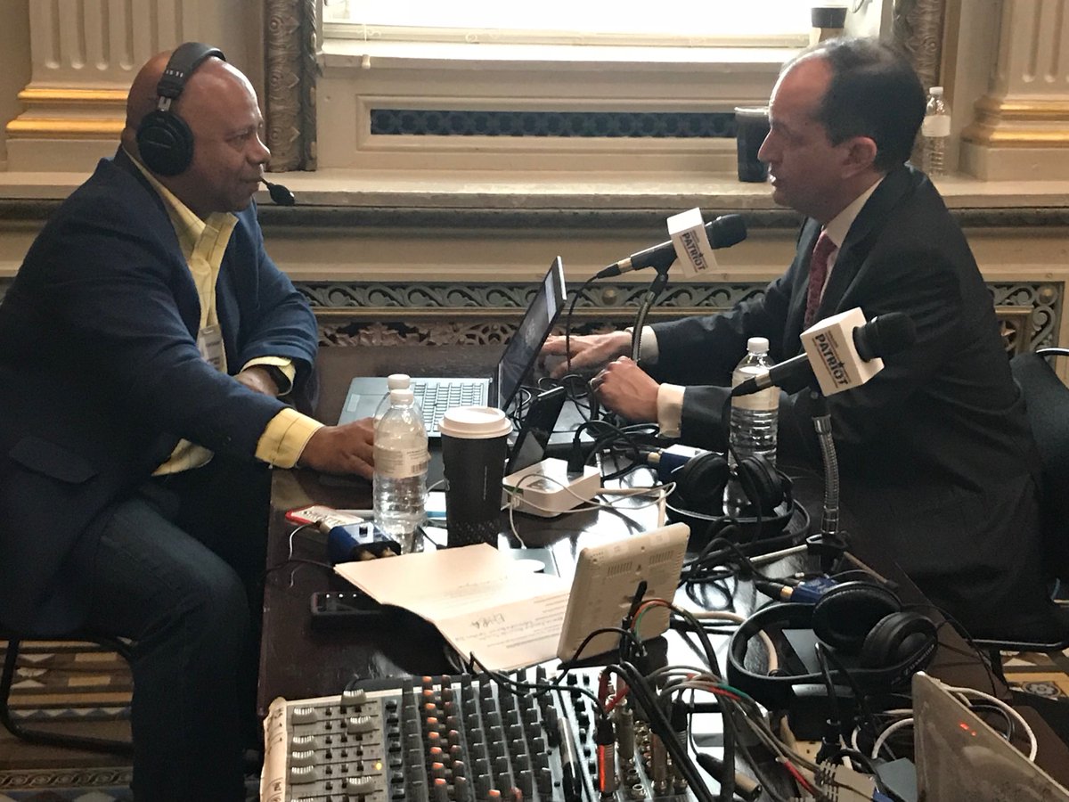 U.S. Secretary of Labor Alexander Acosta speaking with a radio report at the White House Media Row.