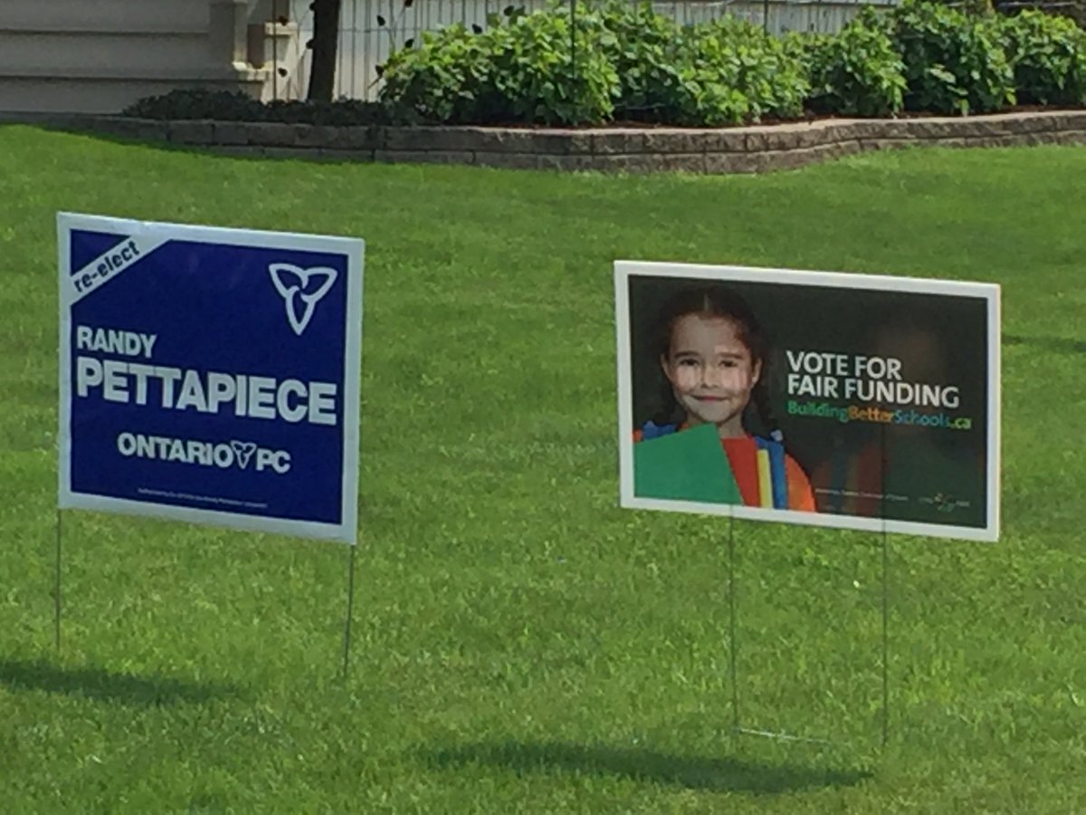 jonjones411's tweet photo. I saw these signs on the same lawn recently. Seriously. I think visual oxymorons are now a thing. Even if you’re politically confused, be sure to vote tomorrow. https://t.co/Nx2q5CC2aK