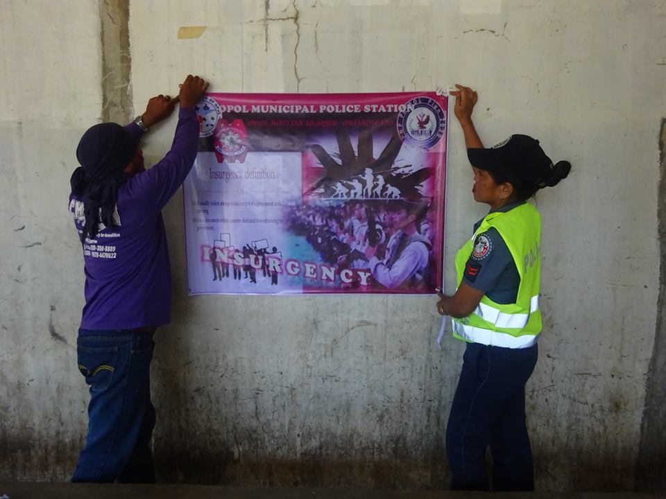 OPOLMPS's tweet photo. HANGING OF TARPAULIN RE: ANTI- INSURGENCY @ OPOL PUBLIC TERMINAL https://t.co/NQ0tTcoRxb