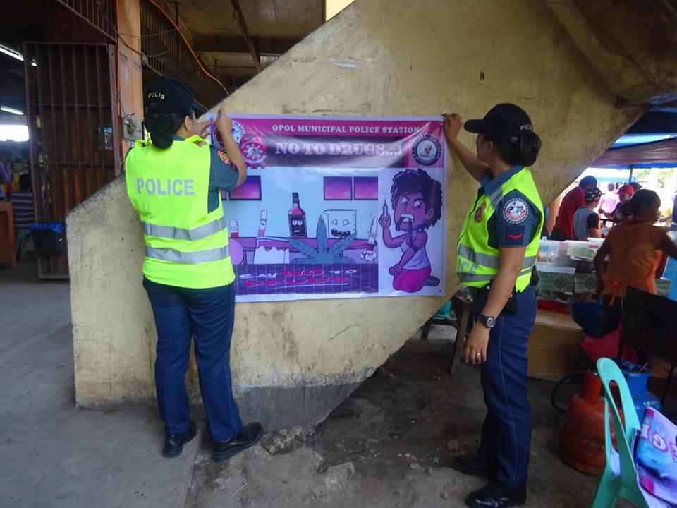 OPOLMPS's tweet photo. HANGING OF TARPAULIN RE: INTENSIFIED CAMPAIGN AGAINST ANTI-ILLEGAL DRUGS @ OPOL PUBLIC https://t.co/BJfT3aMehX