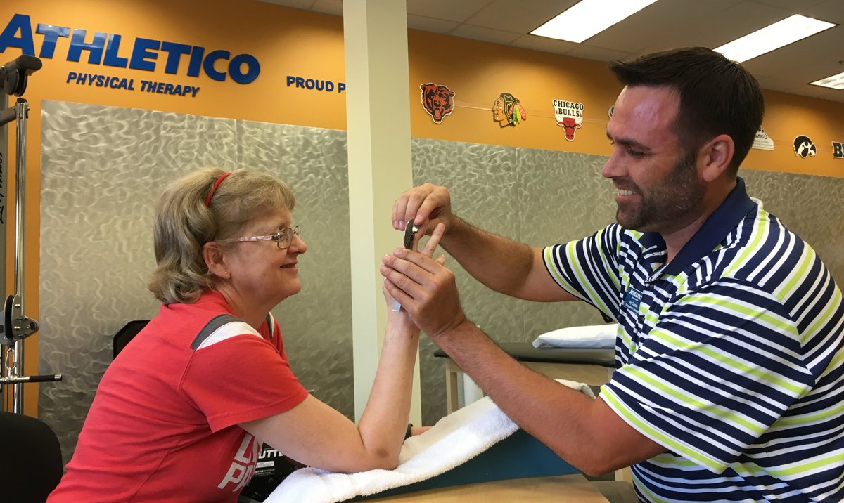 Athletico's tweet photo. #StaffSpotlight: Jay, a #HandTherapist at Athletico #SiouxFalls Central is treating a patient who has an injury to the tendon that straightens the middle joint of the finger. Thanks to Jay &amp; all hand therapists for the work they do to improve the lives of patients. 👐  #HTW2018 https://t.co/5h32RoCadY
