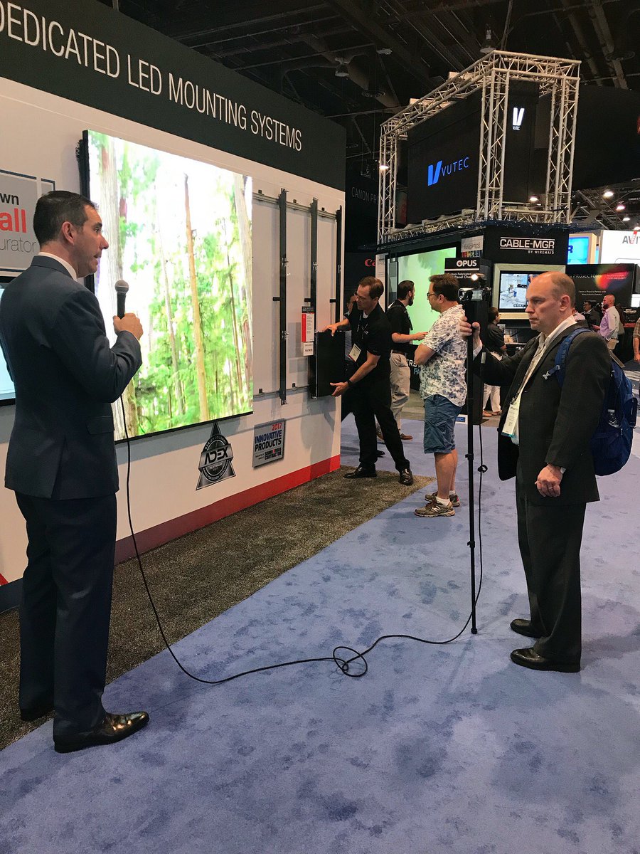 PeerlessAV's tweet photo. .@NickBelcore showing Bob Archer, @commintegrator, our award-winning LED Video Wall Mounting System &amp; LED Configurator. Check it out in booth C2947! #InfoComm18 #AVTweeps https://t.co/n5ZynoMeBs