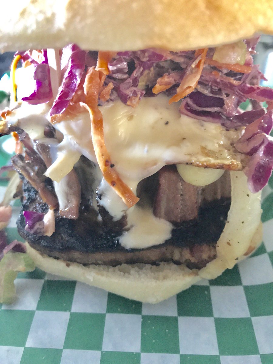 How about BEEFY DUDE!!! Thick sliced beef brisket on top of a slab of meatloaf topped with grilled onions, cheese and slaw