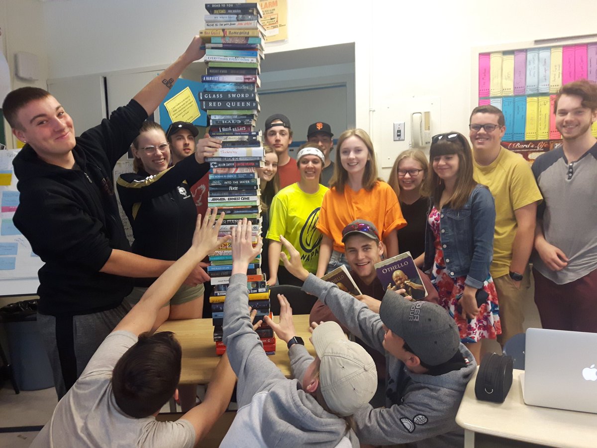 MsLatchmore's tweet photo. While making reading ladders these almost graduates requested a group pic with a tower of enjoyed books - #readisfun! #ndssreads #beststudents! https://t.co/1mtzIPR78m
