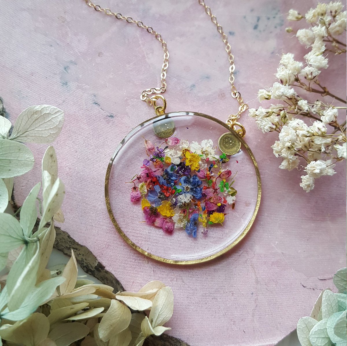 Etsy's tweet photo. Pressed-flower jewelry is on the rise. These confetti-looking beauties look like they’re having a party in there. 🌸 https://t.co/8KtoODlDPx https://t.co/vH9FiJrn1A