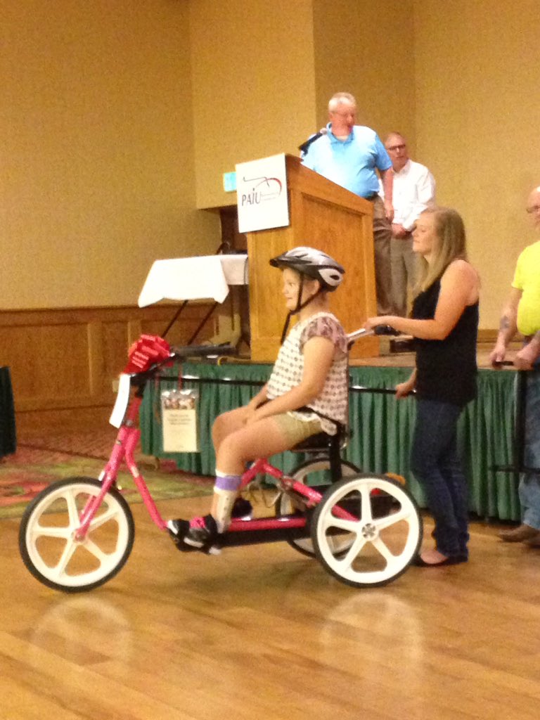 PAIU's tweet photo. What a way to end our #paiu2018 conference raising more than $14k for @VarietyKids &amp; awarding two pink adaptive bikes!! https://t.co/f8Tu93hLuc