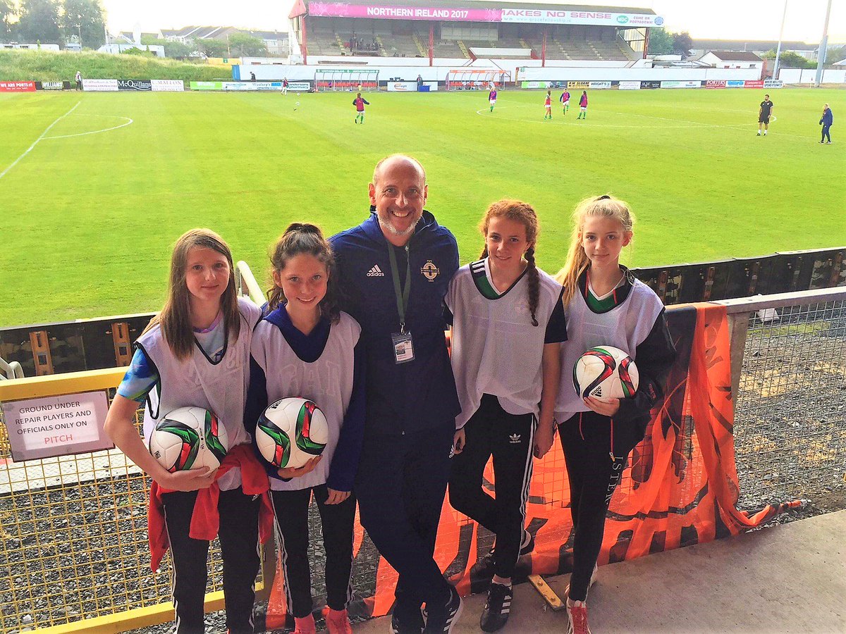 IFA coach Robert Davidson with four of our junior team members who represented us as ball girls at Fridays international between Northern Ireland v Netherlands at Shamrock Park.