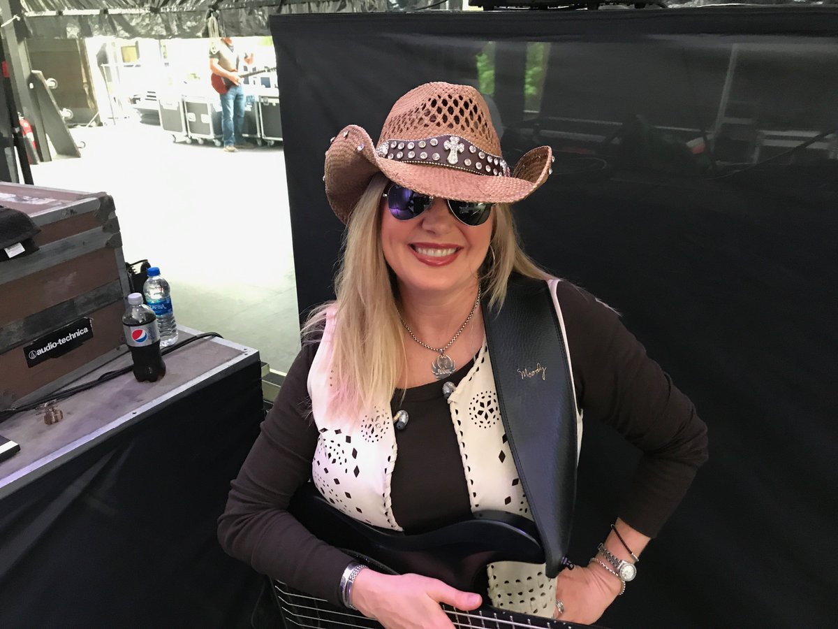 Michelle Poe, bass player with Hank Williams Jr. Michelle, is wearing our Black , 4” strap in this photo.  If you experience shoulder discomfort / pain from playing , please consider purchasing one of our straps in any of our widths#bass#bassplayers#countrymusic#michellepoe