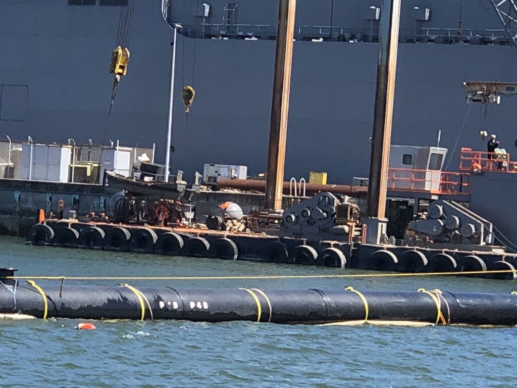 Benioff's tweet photo. Great day with @TheOceanCleanup and @BoyanSlat at the functional prototype of The Ocean Clean Up at Alameda Naval Station.  Large scale prototype to leave for the high seas live in September, and real garbage collection in December.  Let's get the plastic out of the ocean! https://t.co/SC3IB5YJ0G