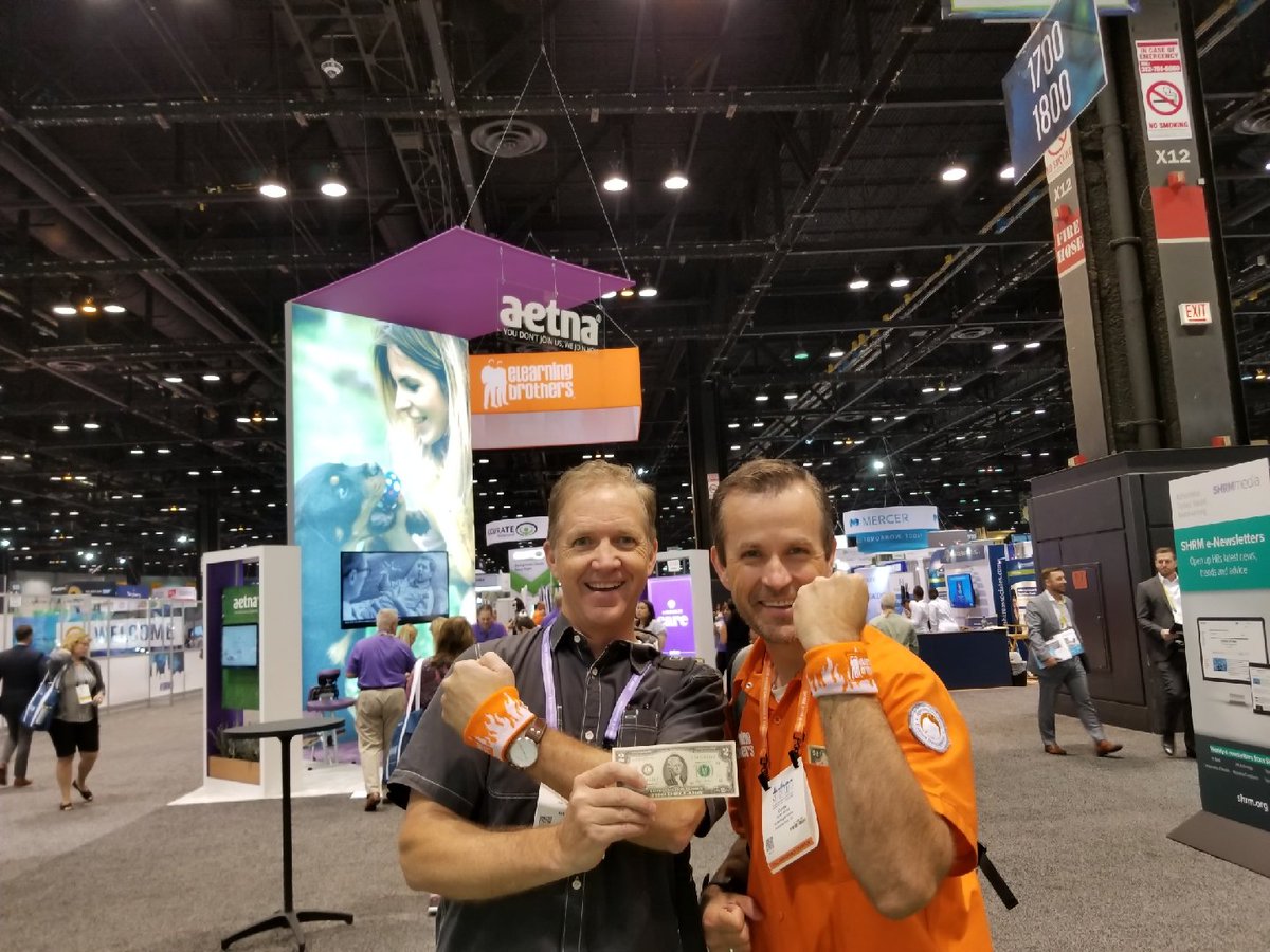 Joe Tate <a href="/JoeT8r/">@joe.t8</a> just won a brand new $2 bill 💵 for stopping by @elearningBros booth #1650 and picking up a bro band. #shrm18
