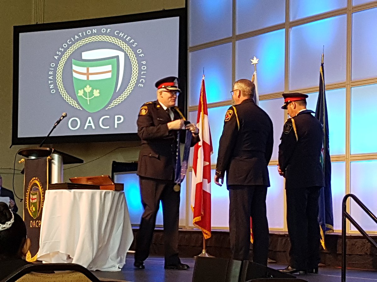 PhilCrnko's tweet photo. Congrats to Chief John Pare from London @John_Pare and Chief Eric Gert of Hamilton on being invested as Sergeants at Arms by @Chief_BLarkin at the #OACP2018 opening! Those heavy chains of office are in good hands! @MotoSolutions is proud to attend and support #OACP18! https://t.co/IZlTrs4F6E