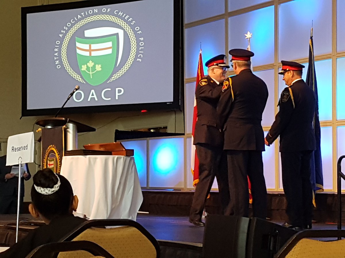 PhilCrnko's tweet photo. Congrats to Chief John Pare from London @John_Pare and Chief Eric Gert of Hamilton on being invested as Sergeants at Arms by @Chief_BLarkin at the #OACP2018 opening! Those heavy chains of office are in good hands! @MotoSolutions is proud to attend and support #OACP18! https://t.co/IZlTrs4F6E