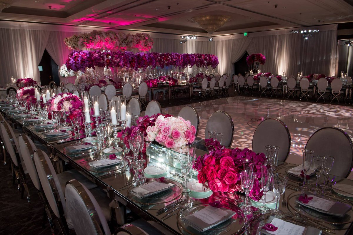 The couple's reception space was decorated with mirrored elements, candlelight, and lush blooms in shades of blush, fuchsia, and hot pink. bit.ly/2CmtDY6 <a href="/BobGailEvents/">Allyson Levine</a> <a href="/whitelilacinc/">White Lilac Inc.</a> <a href="/RevelryDesign/">Revelry Event Design</a> (John Solano Photography) #pinkwedding