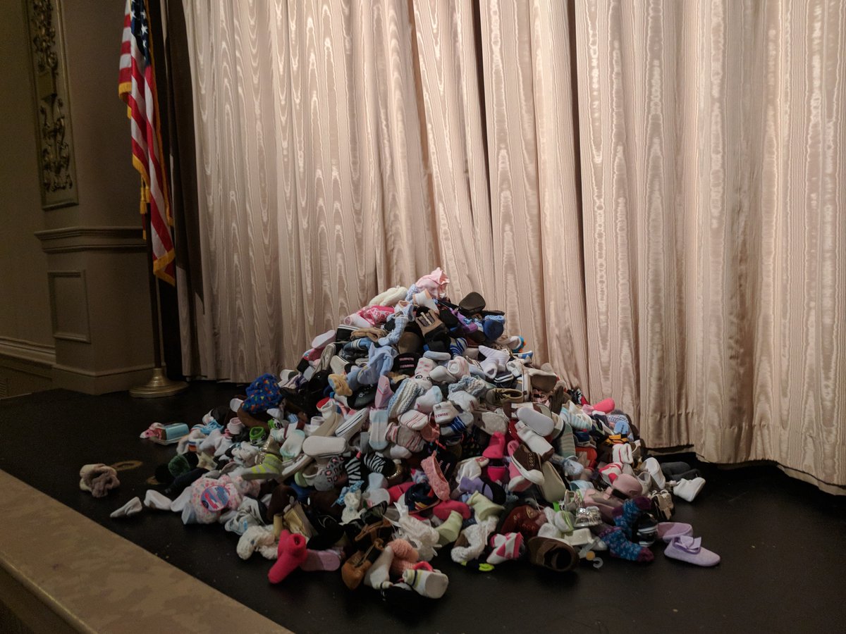 GCRTL's tweet photo. These baby booties represent the 1,971 abortions that have taken place in Ohio since Jan 1. Today, we had a turn away. Turn aways are how we went from 18 babies aborted daily in Cbus to now 12 babies. It's an amazing day for life because of your prayers and support. #Cbus4Life https://t.co/v2yf20dCS9