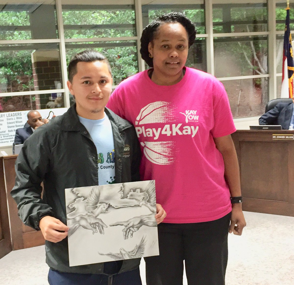 VanceCoSchools's tweet photo. Alejandro Castorela, a graduate this year of Southern Vance High, is honored at the Board of Education meeting tonight. He is shown holding his “Creation of Art” sketch with his art teacher Amy Simpson. His work won third place in the district Congressional Art Contest. https://t.co/LQGWelkJD5