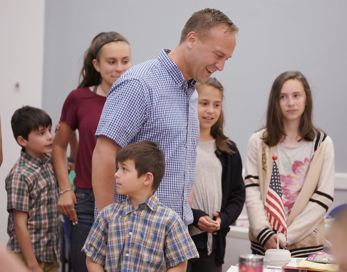 With his five children at his side, Democratic gubernatorial candidate Adam Cote <a href="/CoteForMaine/">Adam Cote</a> laughs with an election clerk while getting his ballot to vote in Springvale on Tuesday morning.