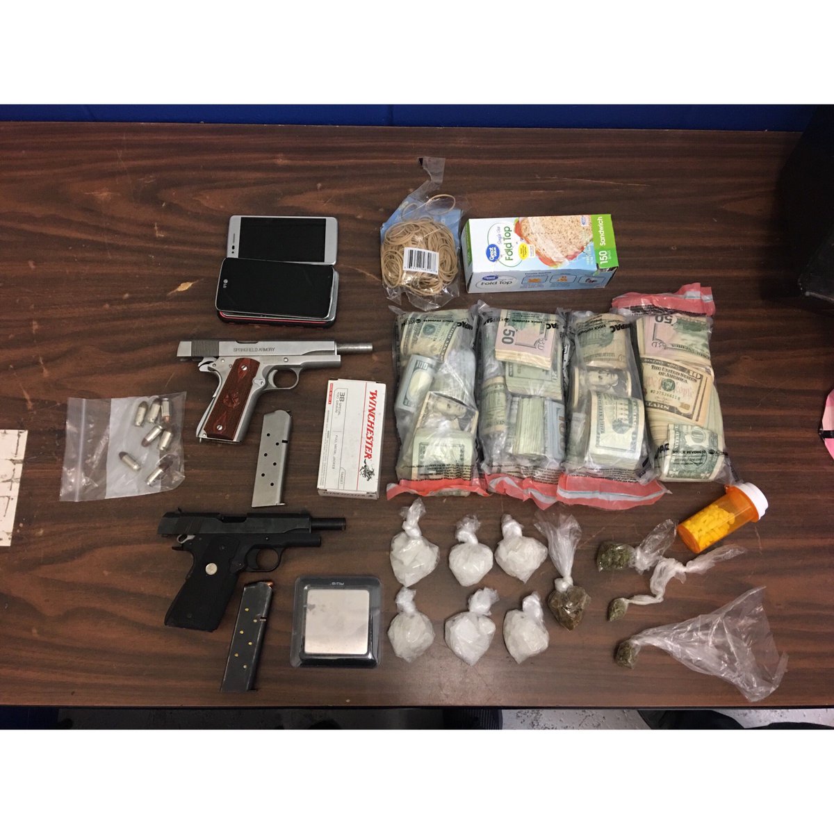 LMPD's tweet photo. Shout out to 4th Division Officers Tyler Blissett and Jay Dolak! 6.5 ounces of meth, 1.2 ounces of heroin, 69 Lortab pills, some weed, two stolen handguns, and a bunch of cash. No tip is too small! #LMPD #4thDivisionPride #TippinAintSnitchin #574LMPD #ThatsMethedUp #PewPewProbs https://t.co/oSXPAVyOQo
