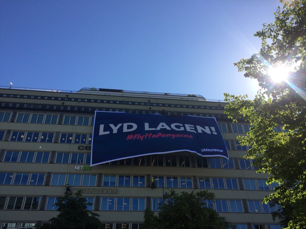 greenpeaceSE's tweet photo. BREAKING: Vi har nu firat ner en banner utanpå AP-3:s kontor på Vasagatan. Vi uppmanar den svenska myndigheten att lyda be grundlag och följa #parisavtalet genom att #FlyttaPengarna NU! ✊️ https://t.co/vWu1sKd0cH
