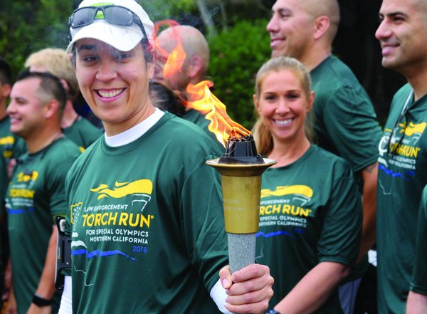 The torch is taken up by CHP from Watsonville Police in the Law Enforcement for Special Olympics N. Calif 2018 run across SC county Wed.. #RPnews @RegPaj #TorchRun