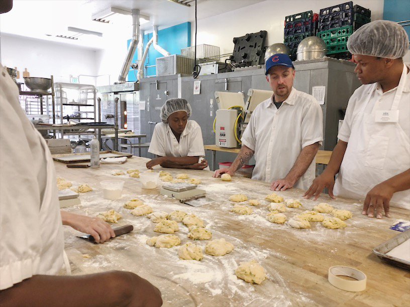 BreadProject's tweet image. Yesterday our Bakery Bootcamp trainees learned how to shape bread and sweet potato buns. Here Chef Gram is demonstrating how to create the perfect bun shape.