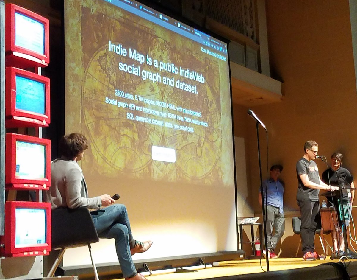 Tantek Çelik speaking on stage at the Internet Archive Decentralized Web Meetup showing Indie Map