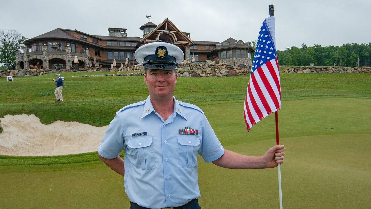 In Wednesday's final round of the #MassOpen, competitors were greeted by a different sight when approaching the 18th green. Continuing annual tradition, @USCG veteran & @GreatHorseClub manager Tom Burzdak served as the flagstick attendant. Read: bit.ly/mass183golf