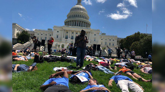 BreakingEmNews's tweet photo. Striking photos of National Die-In Day show students protesting on U.S. Capitol lawn... https://t.co/r0vj3GFU6d